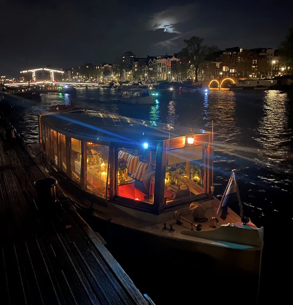 Historic salon boat Energie illuminated in Amsterdam