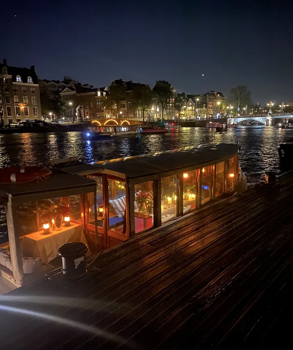 Historic salon boat Energie illuminated on an Amsterdam canal